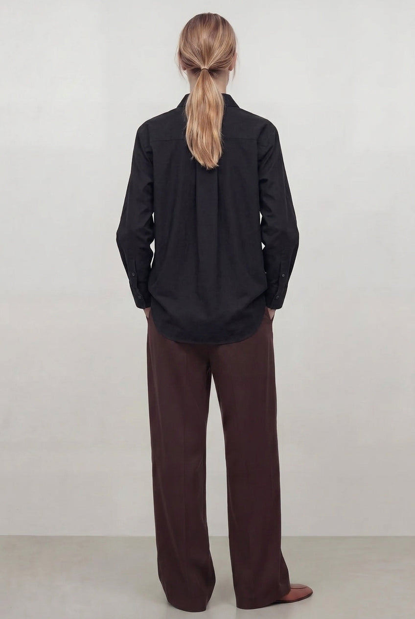 Women wearing a black baby cord shirt