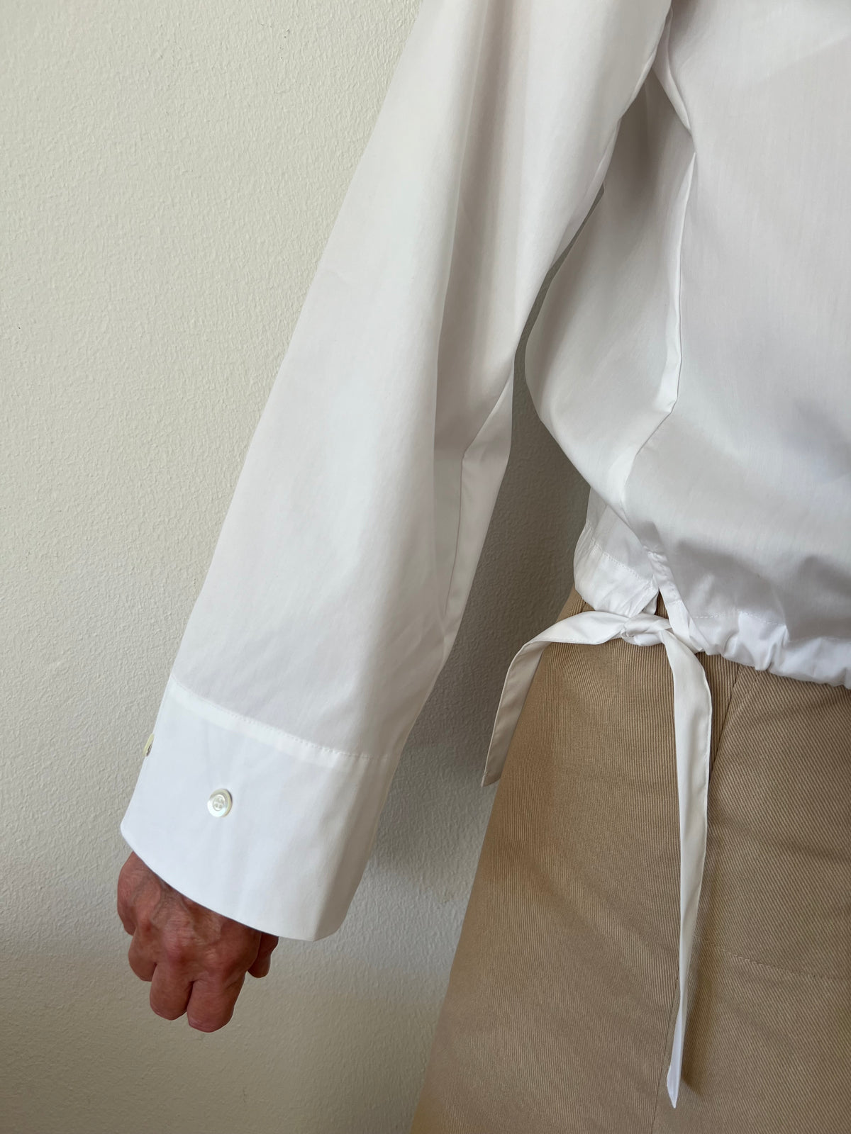 Wide sleeve of a white poplin blouse