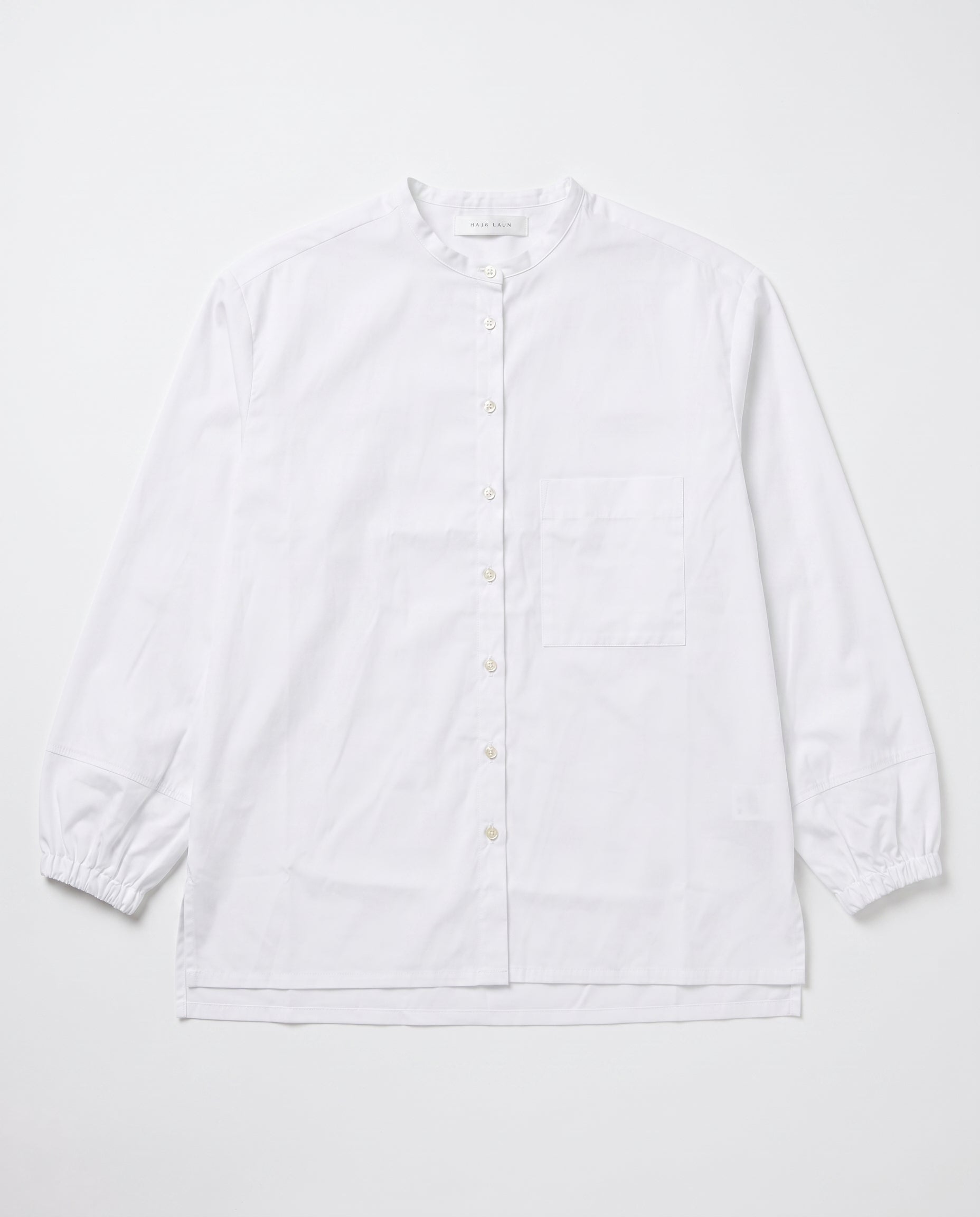 A white long-sleeve button-up shirt with a mandarin collar, a single chest pocket, and elasticized cuffs, l