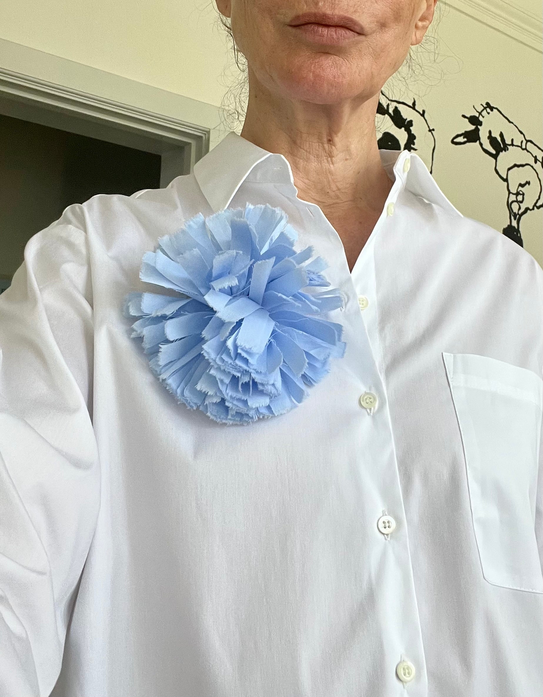Fabric broche in light blue on white shirt