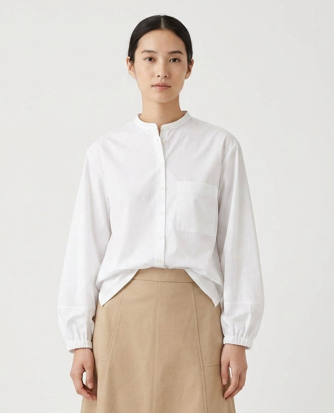 A white long-sleeve button-up blouse 